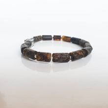 Load image into Gallery viewer, Bracelet with Baltic amber brown and black beads on a white background