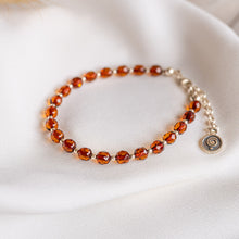 Load image into Gallery viewer, Bracelet with Baltic amber beads on a white fabric background
